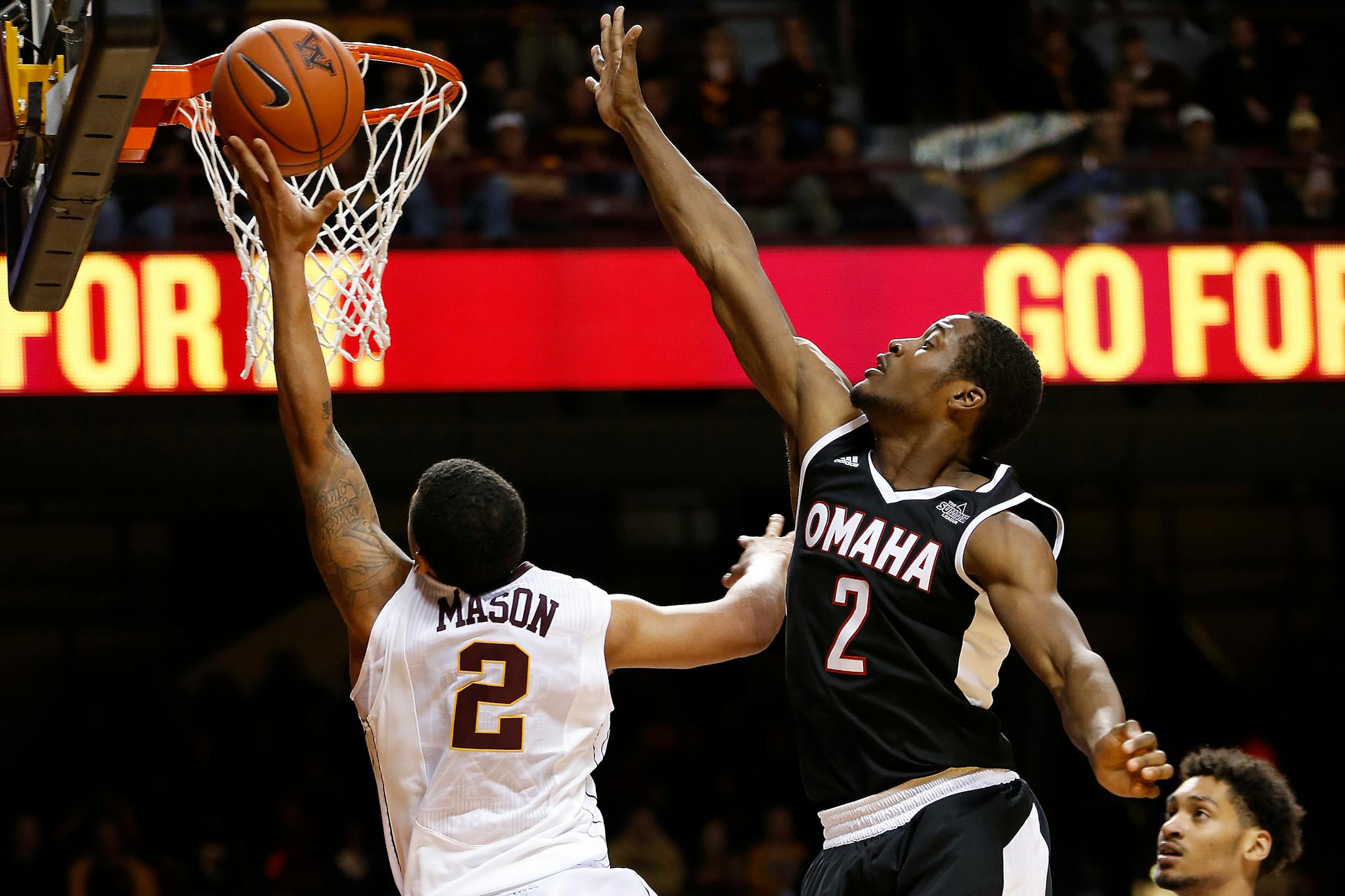 Minnesota guard Nate Mason (2) goes up to the basket against Nebraska-Omaha guard Randy Reed (2) in the second half of an NCAA college basketball game Friday, Nov. 27, 2015 at Williams Arena in Minneapolis. (AP Photo/Stacy Bengs)