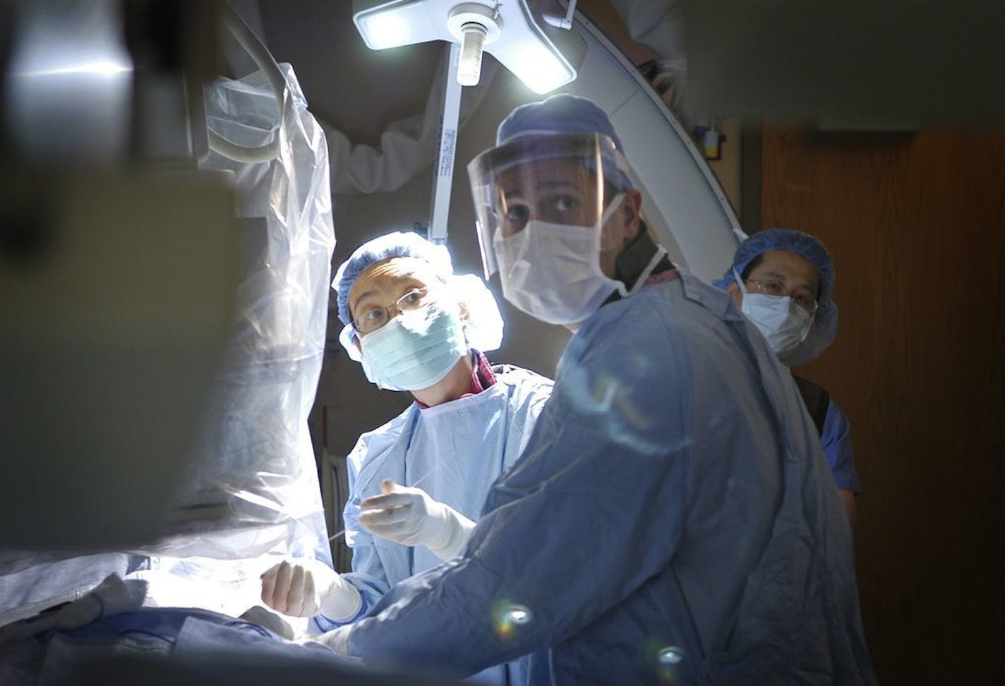 Doctors placed wires for a Medtronic defibrillator in a patient in this file photo from June 2005, watching the placement with the help of an xray fluoroscope.