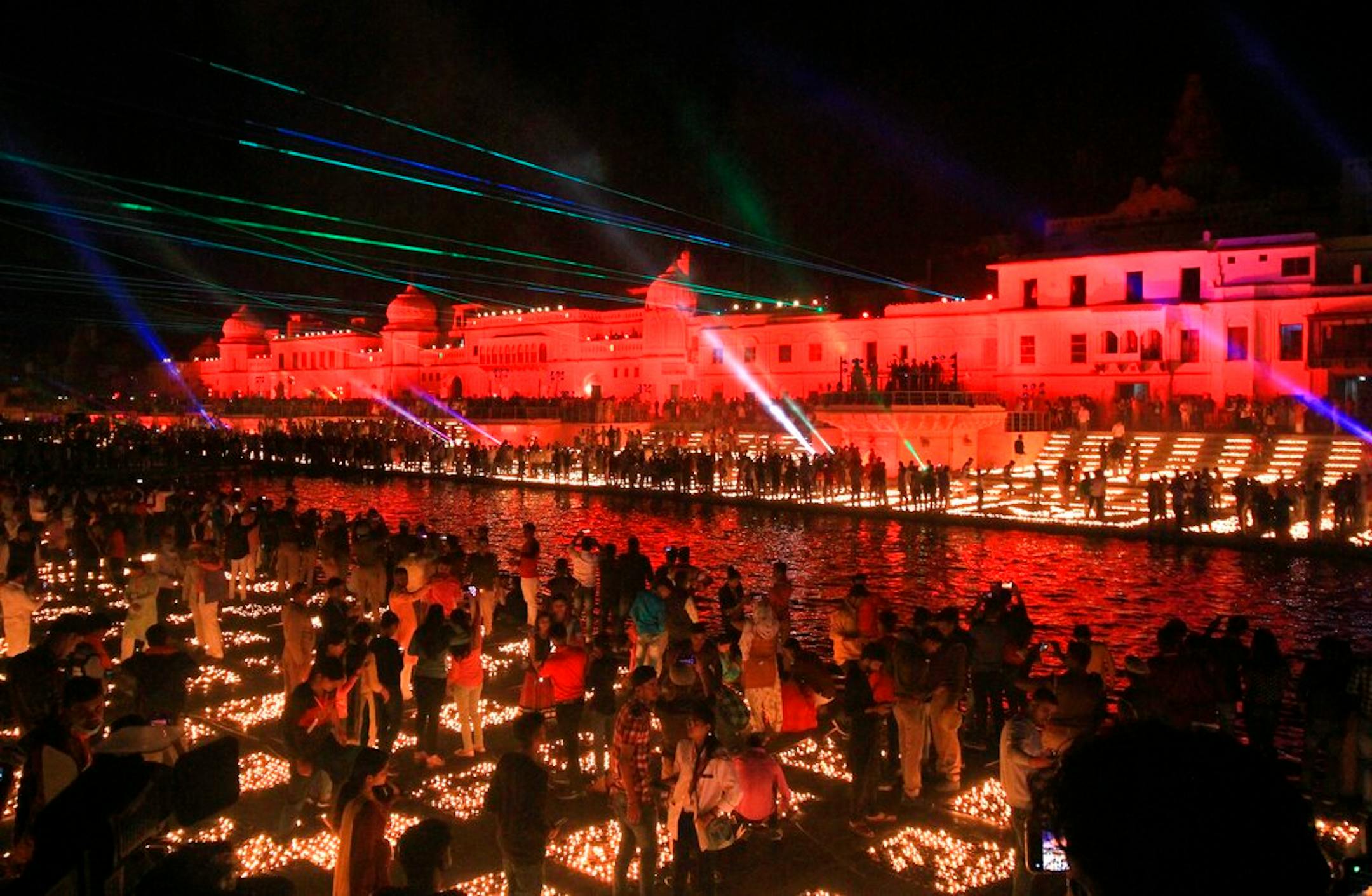 People light lamps on the banks of river Saryu in Ayodhya, India, Friday, Nov. 13, 2020. The northern Indian city of Ayodhya kept its Guinness World Record for a second straight year by lighting more than 584,572 oil lamps and keeping them burning for at least 45 minutes on the banks of the river Saryu as part of the celebration of Diwali, the annual Hindu festival of lights. (AP Photo/Rajeev Bhatt)