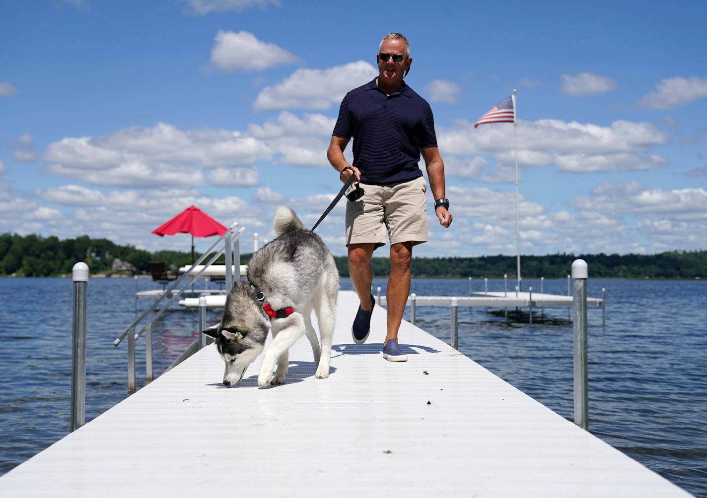 Todd Russell, a commercial real estate adviser, with his Siberian husky, Isabelle, at his East Gull Lake dock.