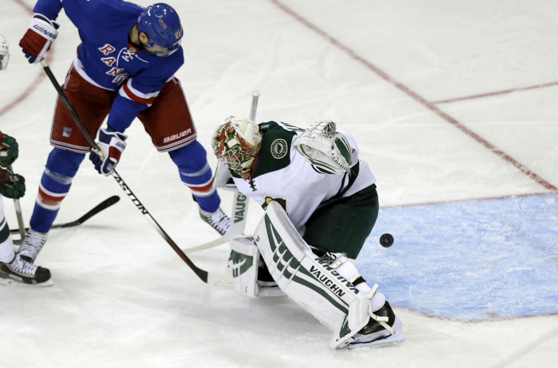 New York Rangers left wing Rick Nash (61) shoots the puck past Minnesota Wild goalie Darcy Kuemper during the third period of an NHL hockey game Monday, Oct. 27, 2014, in New York. The Rangers won 5-4. (AP Photo/Frank Franklin II)