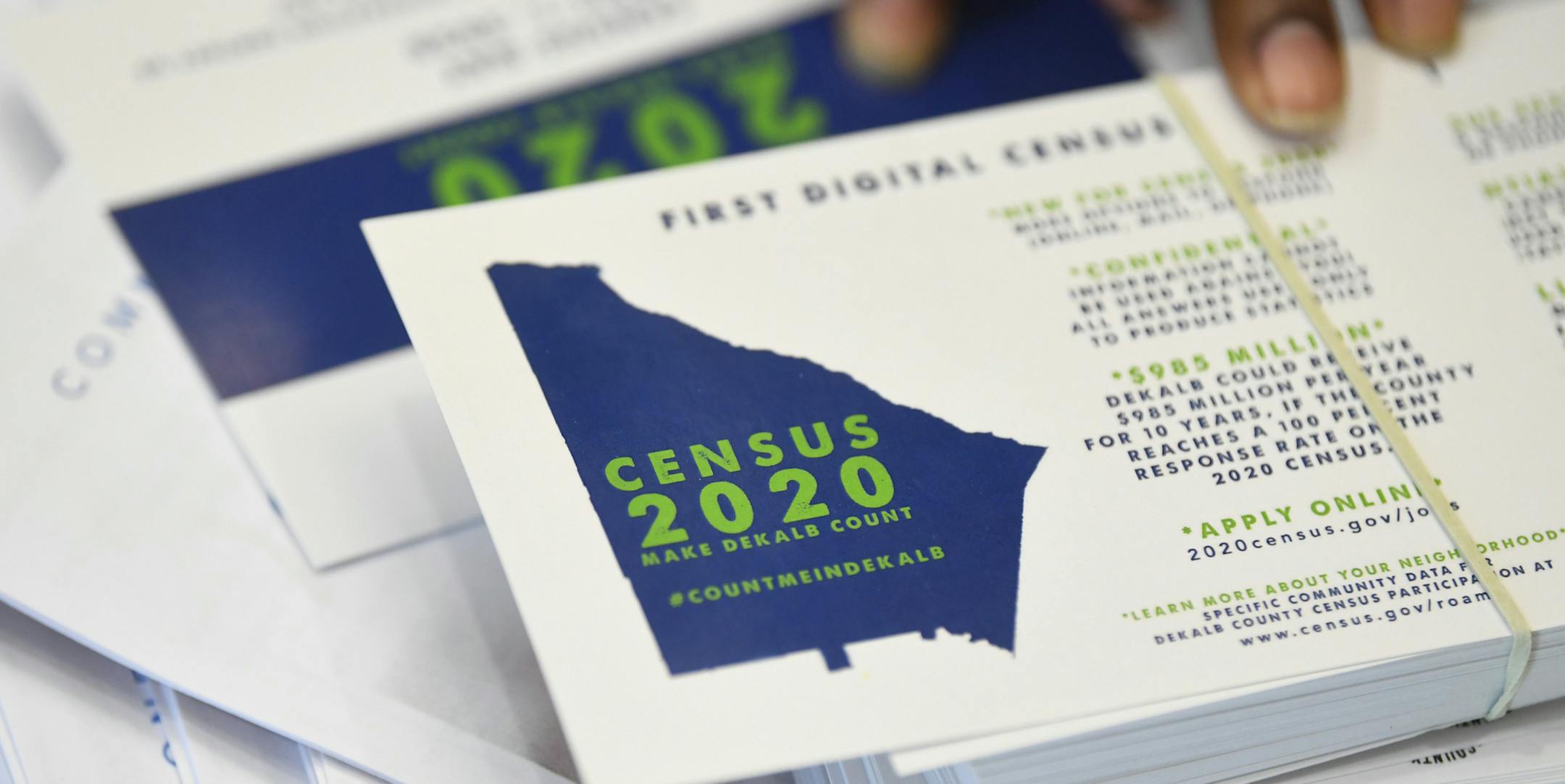 FILE - In this Aug. 13, 2019, file photo a worker gets ready to pass out instructions in how fill out the 2020 census during a town hall meeting in Lithonia, Ga. Facebook says it won't allow interference with the U.S. census on its platform, including posting misleading information about when and how to participate, who can participate and the consequences of taking part. (AP Photo/John Amis, File)