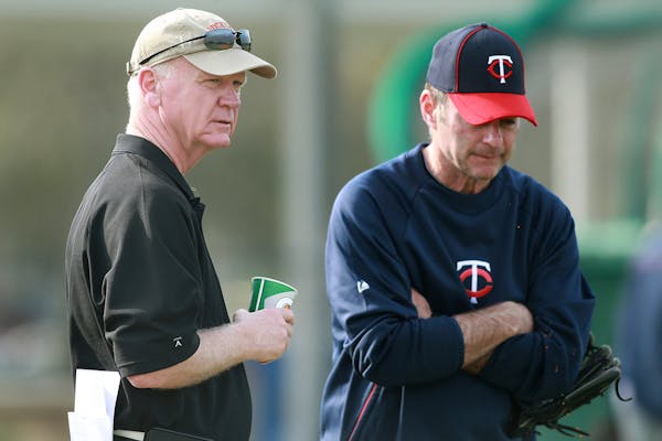 Minnesota Twins general manager Terry Ryan chats with manager Paul Molitor during spring training.