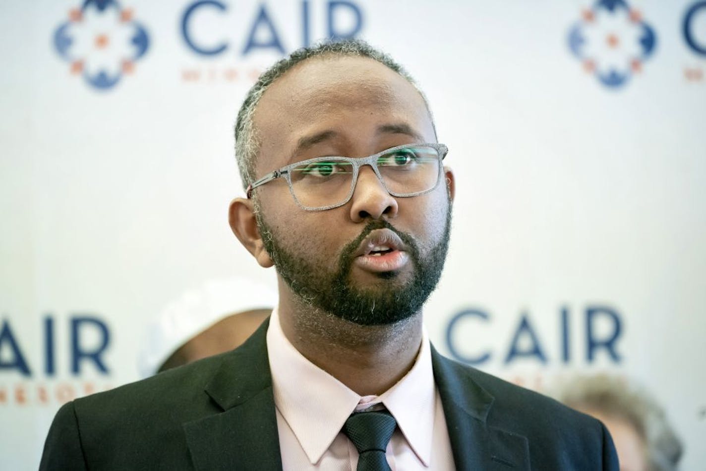 Surrounded by supporters, Jaylani Hussein, Executive Director, CAIR-MN announced a Minnesota-based report which he said detailed an anti-Muslim propaganda network.