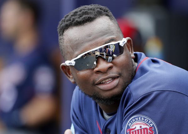 Minnesota Twins' Miguel Sano talks with teammates in the dugout during a spring training baseball game against the Tampa Bay Rays on Friday, March 25,