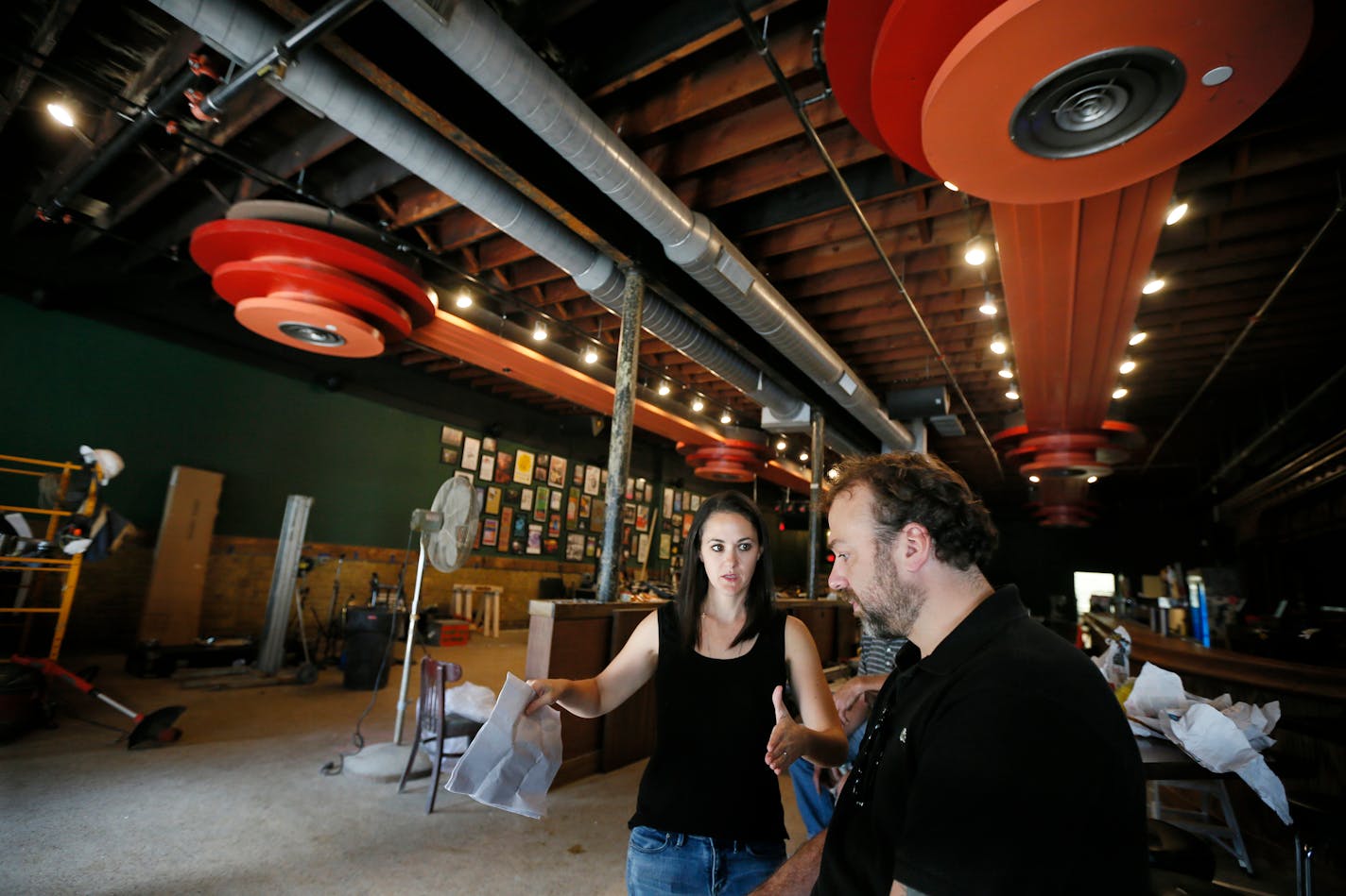 First Avenue's Dayna Frank and Nate Kranz looked over some of the finishing touches underway this week at the Turf Club in St. Paul, which reopens Thursday after a three-month hiatus. / Jerry Holt, Star Tribune