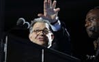 Sen. Al Franken, D-Minn., checks out the podium before the start of the first day session of the Democratic National Convention in Philadelphia, Monda