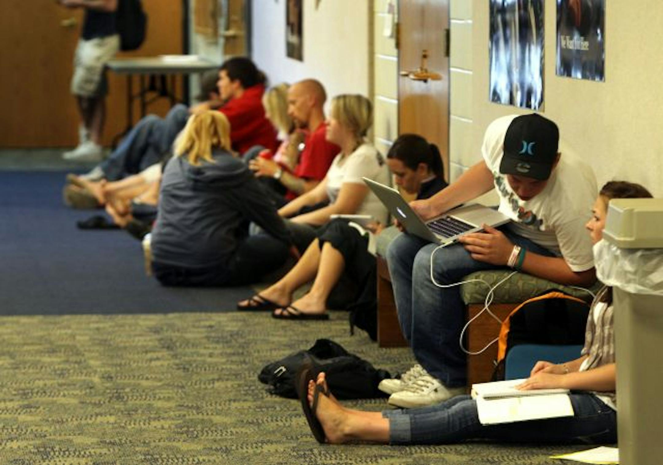 Students pack the hallway area of the theatre lobby's west campus while studying