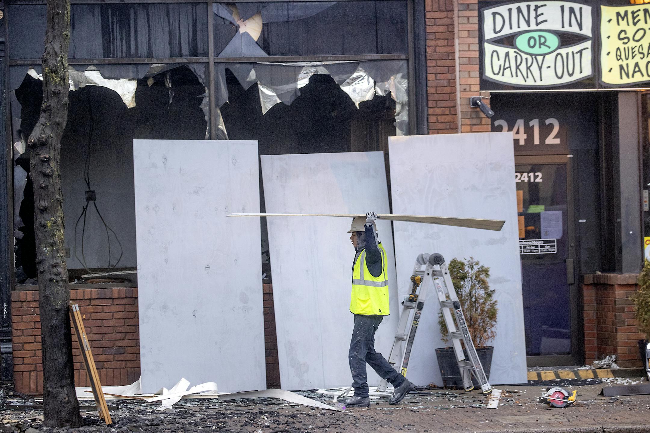 Crew worked on boarding up what remained of the fire that destroyed several businesses on the 2400 block of Central Avenue, Monday, March 23, 2020 in Minneapolis, MN. ] ELIZABETH FLORES &#x2022; liz.flores@startribune.com