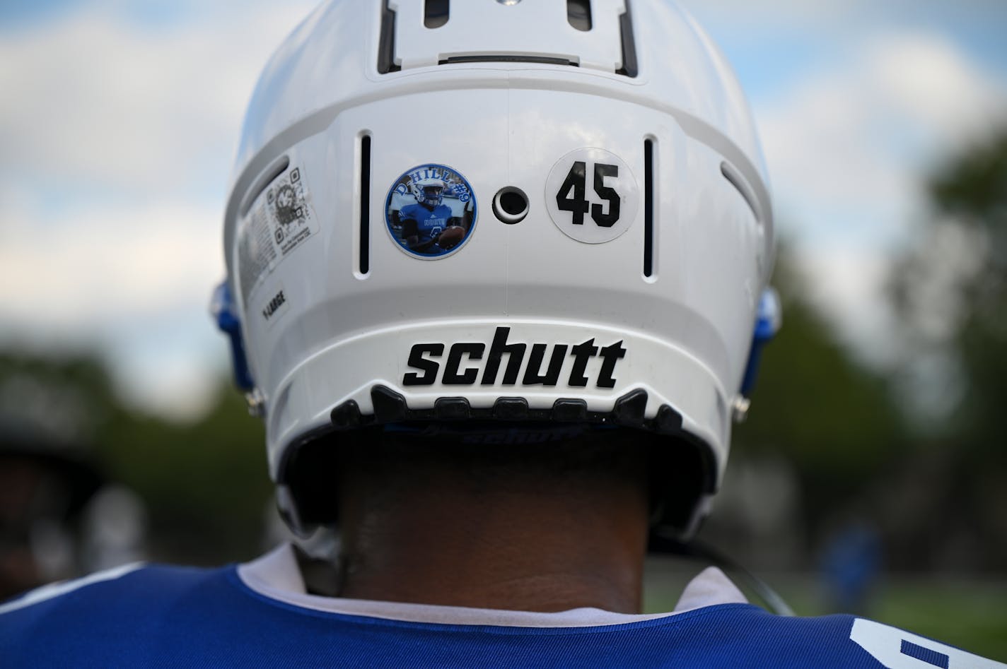 Linebacker Khalil Brown and teammates wear a sticker on their helmets, memorializing late teammate Deshaun Hill, during a Minneapolis North football practice Tuesday, Sept. 20, 2022 at the North High Athletic Field in Minneapolis, Minn.. Hill was shot and killed in February in North Minneapolis. ] aaron.lavinsky@startribune.com