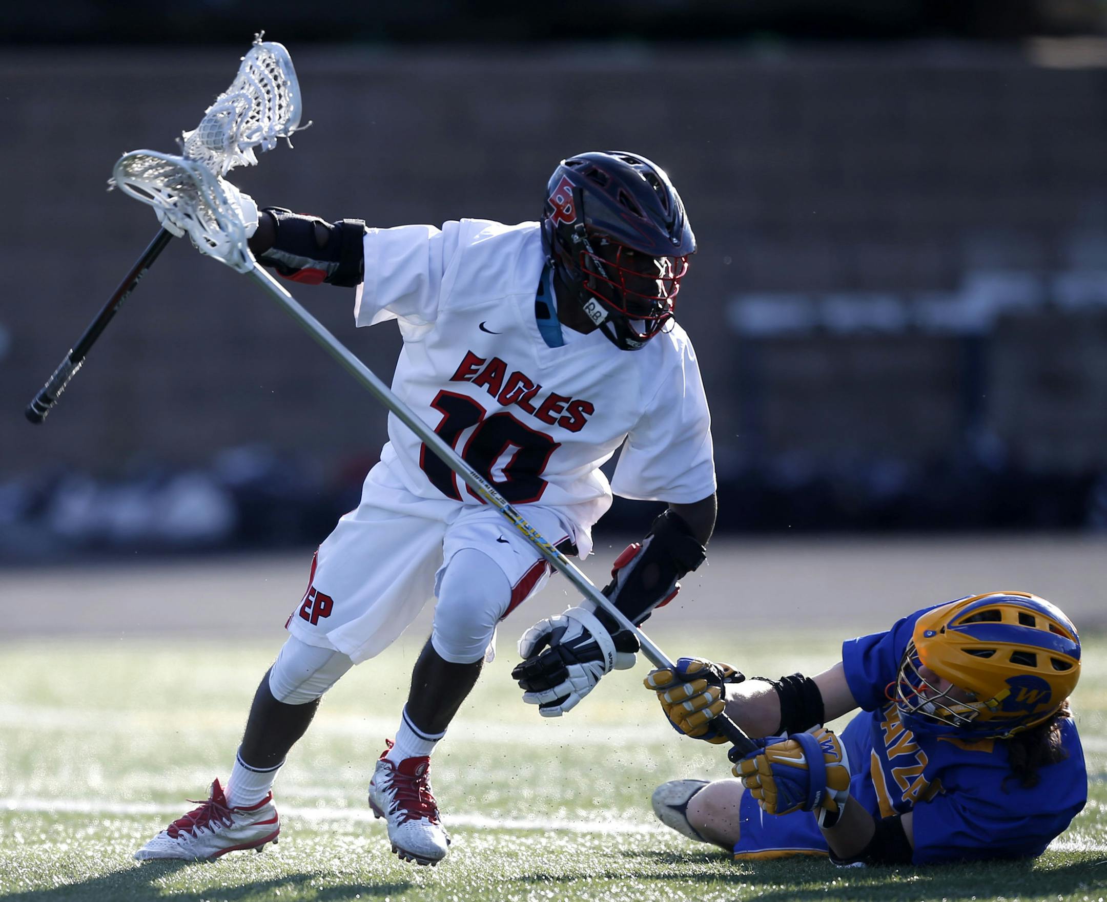 JD Spielmann recovers from a fall during the semifinal game against Wayzata. Eden Prairie beat Wayzata 8 to 7 in overtime, in the boys lacrosse state semifinals on Thursday night at Chanhassen High School. ] MONICA HERNDON monica.herndon@startribune.com Chanhassen, MN 06/12/2014