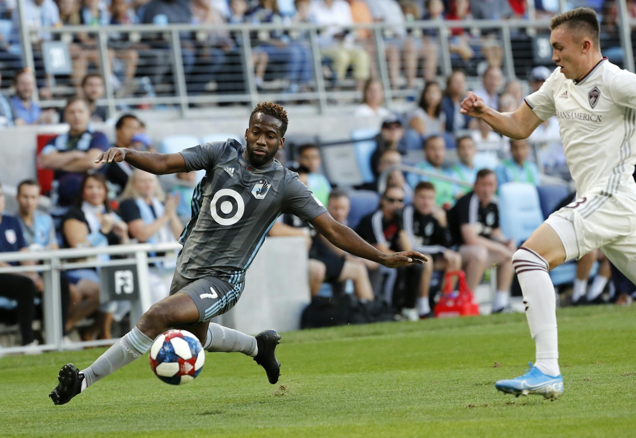 Minnesota United midfielder Kevin Molino (7) kicked the ball as Minnesota United midfielder Ethan Finlay (13) pursued him during the first half.