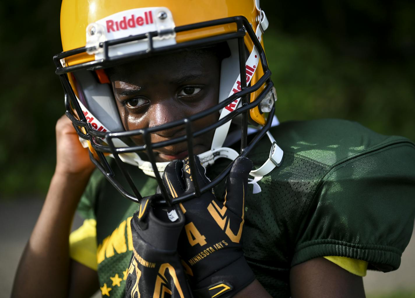 Damarius Miller, 10, adjusted his helmet before running a drill at Wednesday's practice. "I was afraid to get shot," said Miller of the recent shooting which took place near his team's practice. "I dropped down, rolled on the ground and ran around the corner" to get to safety. ] aaron.lavinsky@startribune.com Bullets flew over a north Minneapolis football field where youngsters were practicing on an early summer afternoon and sent the athletes and adults running for their lives, and their coach