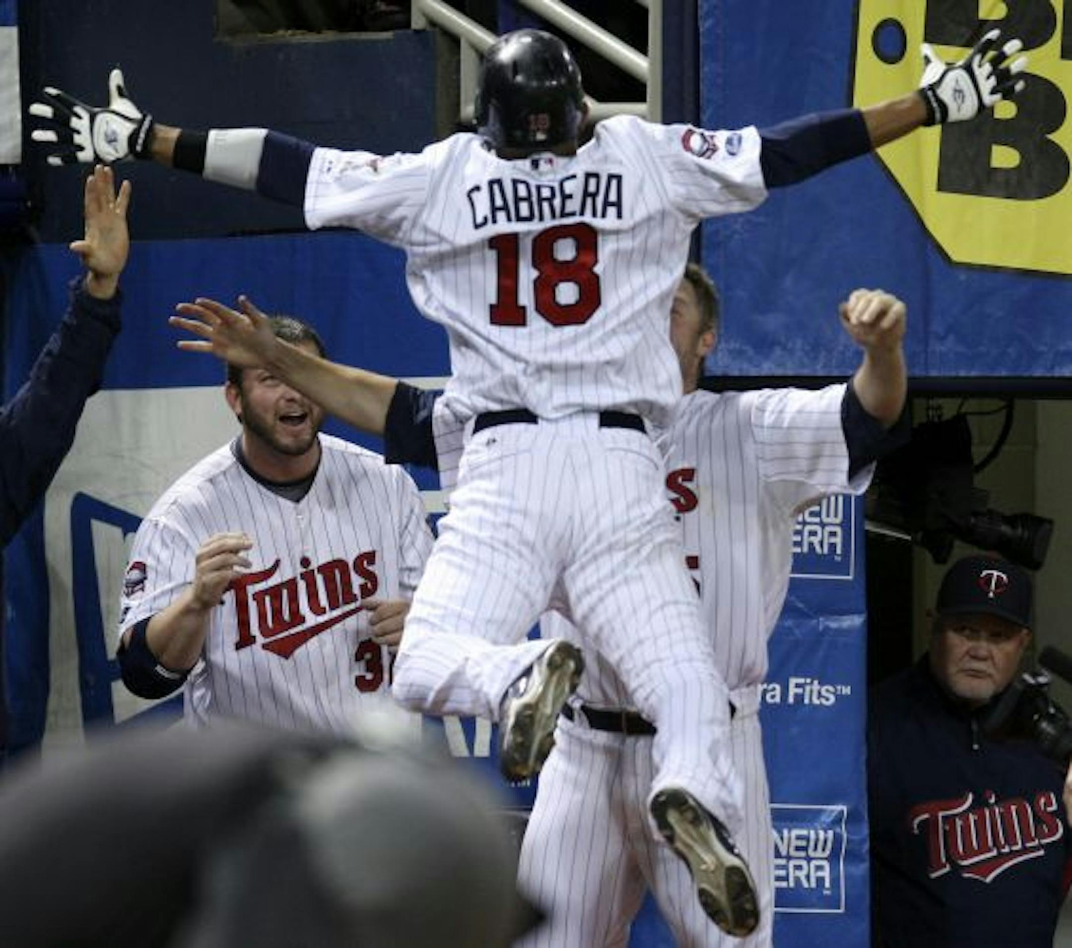 Orlando Cabrera jumped into the arms of Michael Cuddyer after hitting a two-run homer in the seventh inning.