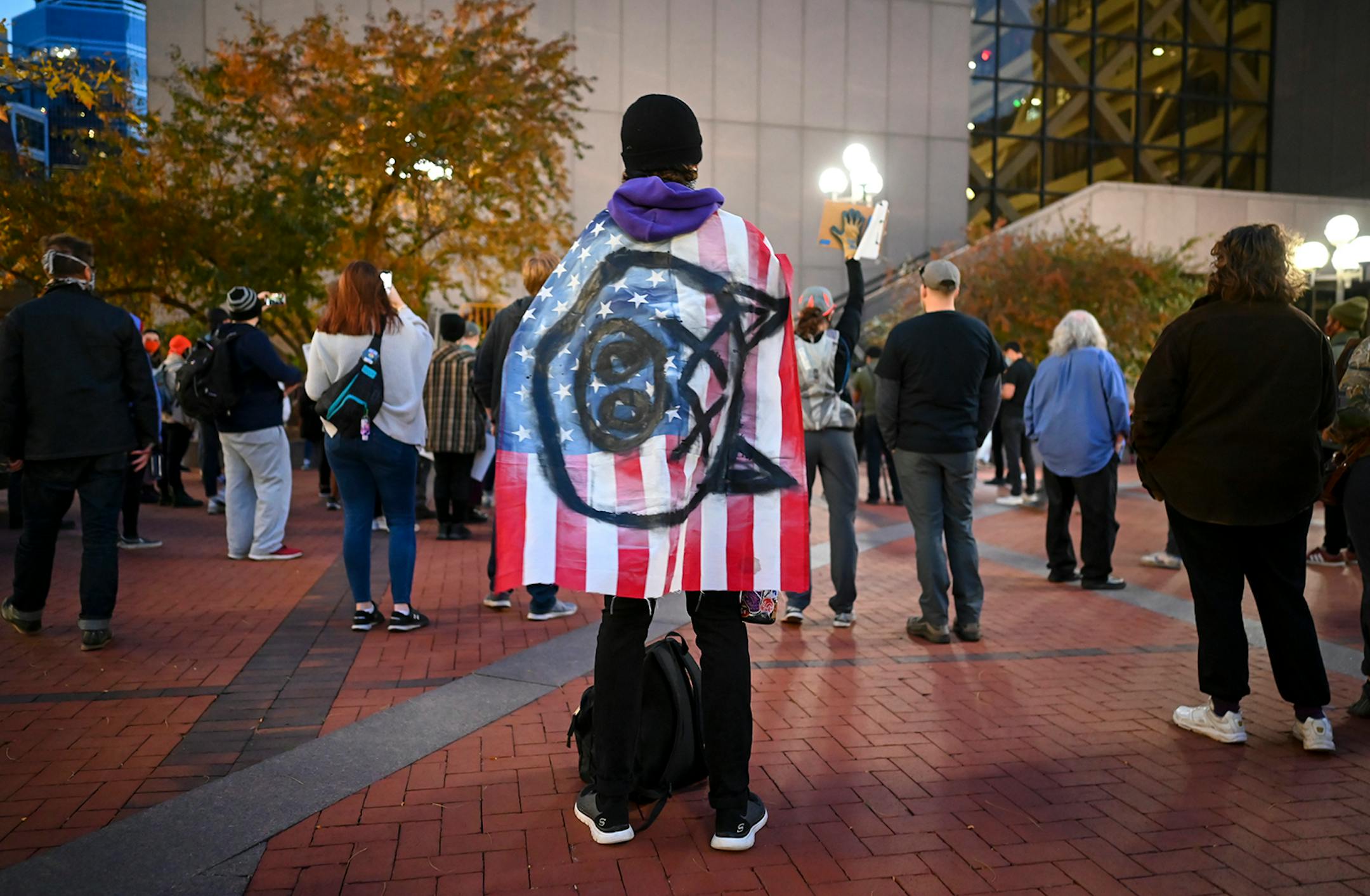 A protester wore a U.S. flag, with a pig painted on it, to Thursday night�s protest outside the Hennepin County Government Center.