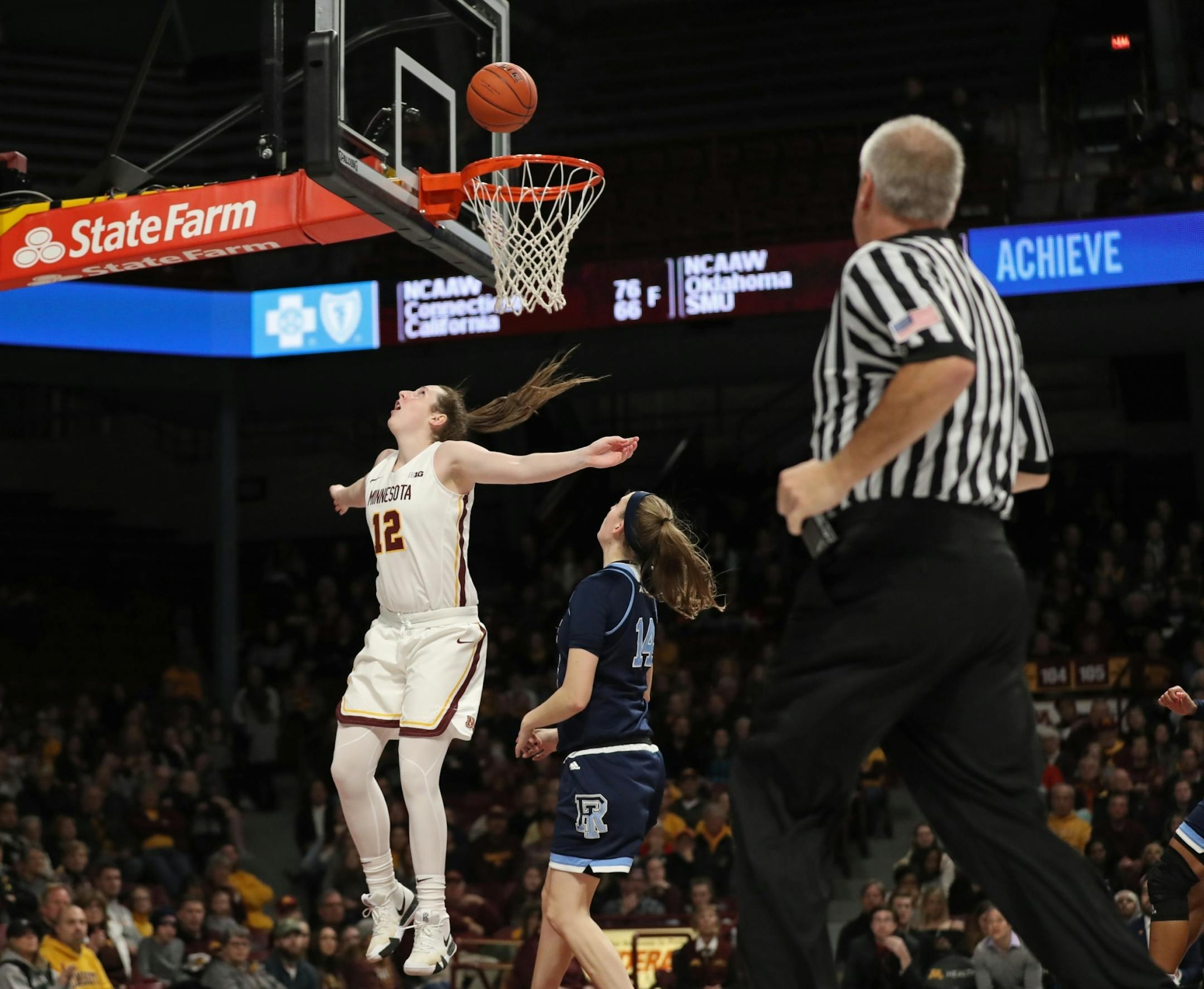 Minnesota Golden Gophers guard Mercedes Staples (12) kept her eyes on the ball as her layup attempt bounced off the rim as Rhode Island Rams guard Erin Jones (14) watched.