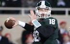 Michigan State quarterback Connor Cook looks to pass against Ohio State during the first quarter of an NCAA college football game, Saturday, Nov. 8, 2