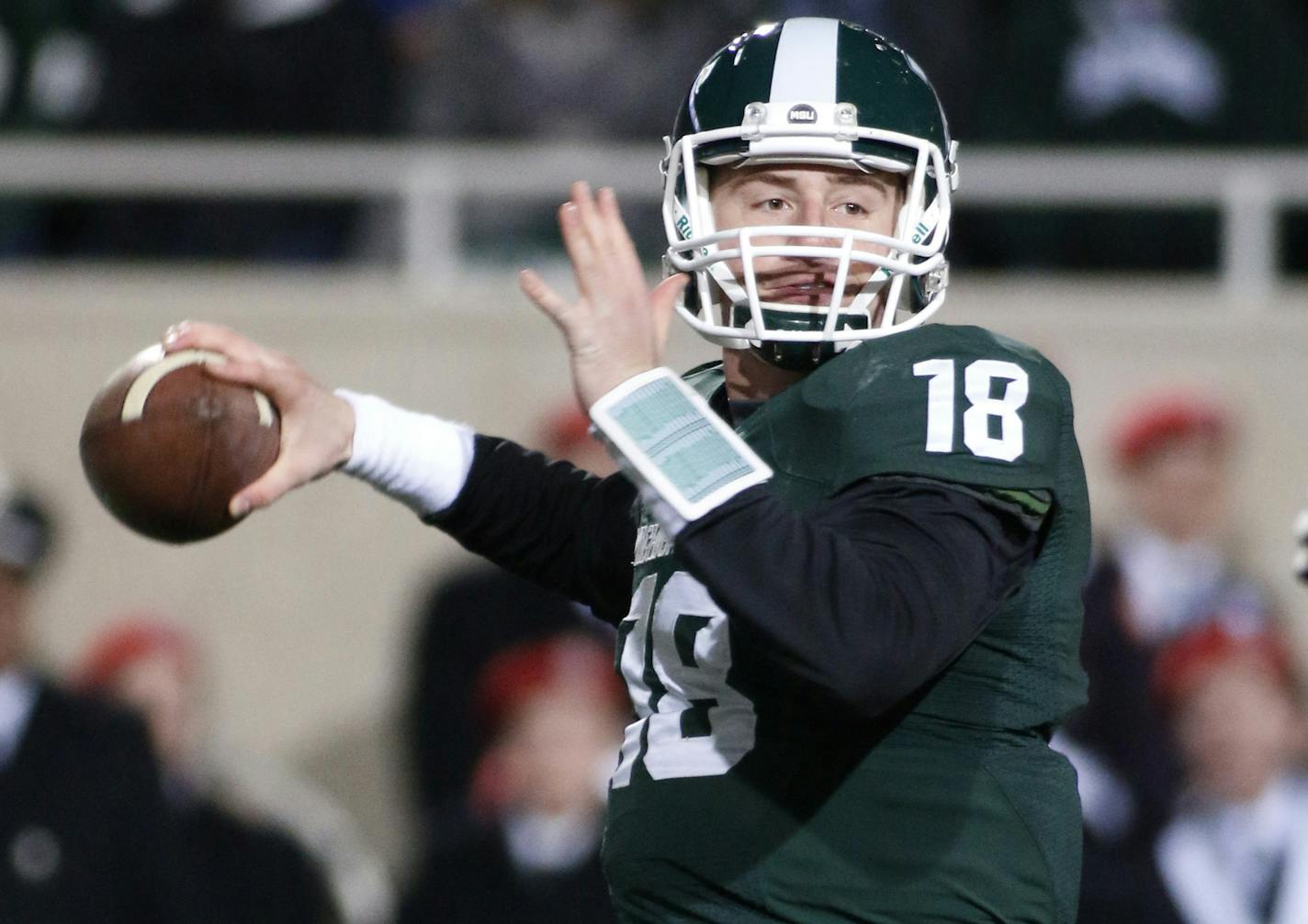 Michigan State quarterback Connor Cook looks to pass against Ohio State during the first quarter of an NCAA college football game, Saturday, Nov. 8, 2014, in East Lansing, Mich. (AP Photo/Al Goldis) ORG XMIT: ELJ103