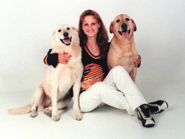 Kathlyn "Katie" Poirier, shown in an undated family handout with her dogs Goldie, right, and Riley.