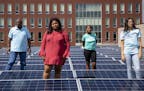 (From left) Pastor Roosevelt Williams, Analyah Schlaeger dos Santos, Khloe Davis and Makayla Freeman pose for a portrait among the solar panels on the