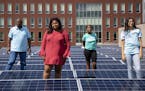 (From left) Pastor Roosevelt Williams, Analyah Schlaeger dos Santos, Khloe Davis and Makayla Freeman pose for a portrait among the solar panels on the