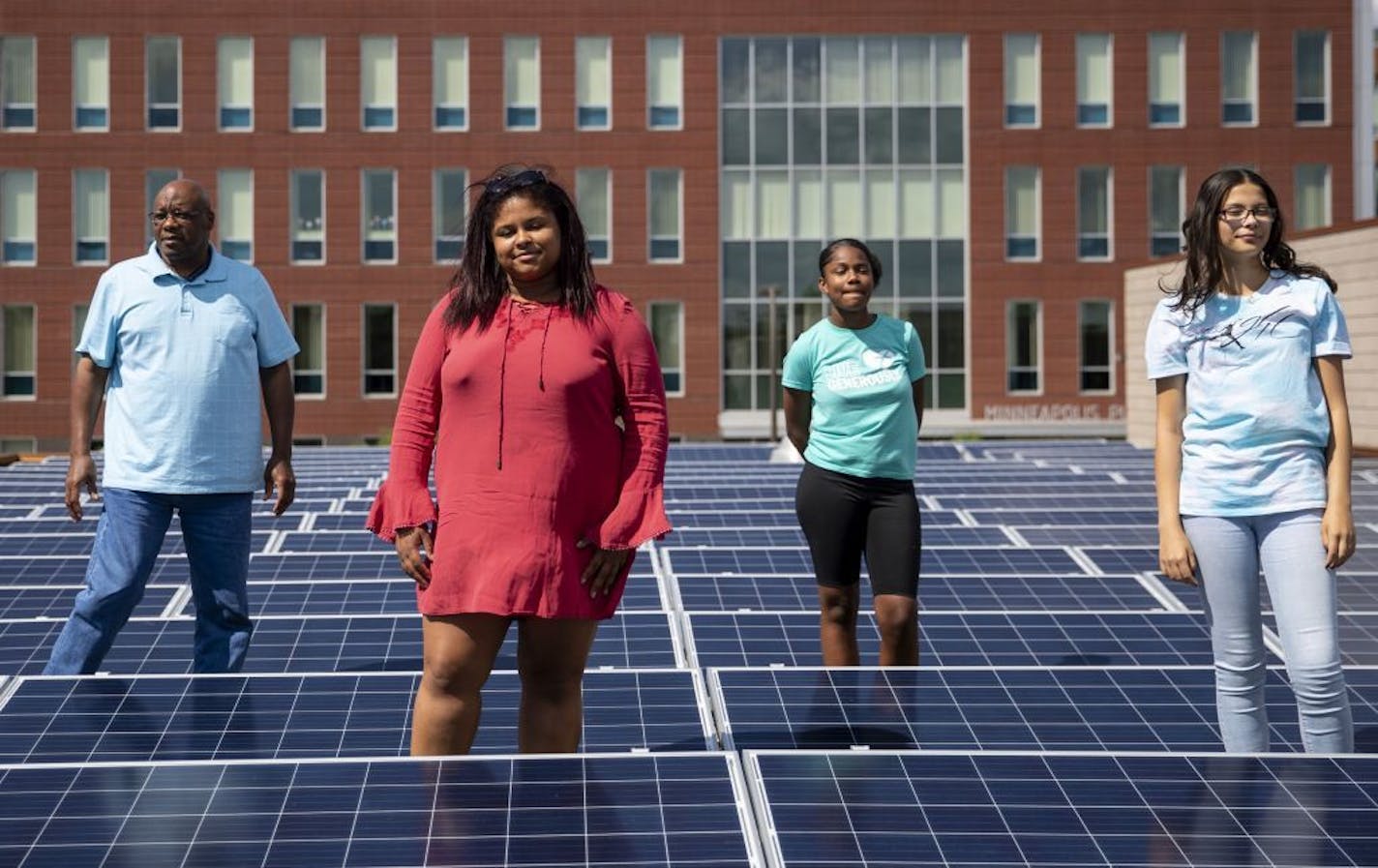 (From left) Pastor Roosevelt Williams, Analyah Schlaeger dos Santos, Khloe Davis and Makayla Freeman pose for a portrait among the solar panels on the roof of Shiloh Temple. Freeman and Davis will be new team members for Youth N' Power. Schlaeger dos Santos is the Environmental Justice Youth Program Director with MNIPL. ALEX KORMANN • alex.kormann@startribune.com In north Minneapolis, Shiloh Temple and a mosque, Masjid an Nur, teamed up to build the first "solar garden" on the North Side, poweri