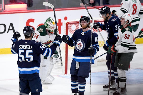 Winnipeg Jets' Mark Scheifele (55) celebrates his goal against the Wild with Kyle Connor (81) during the first period