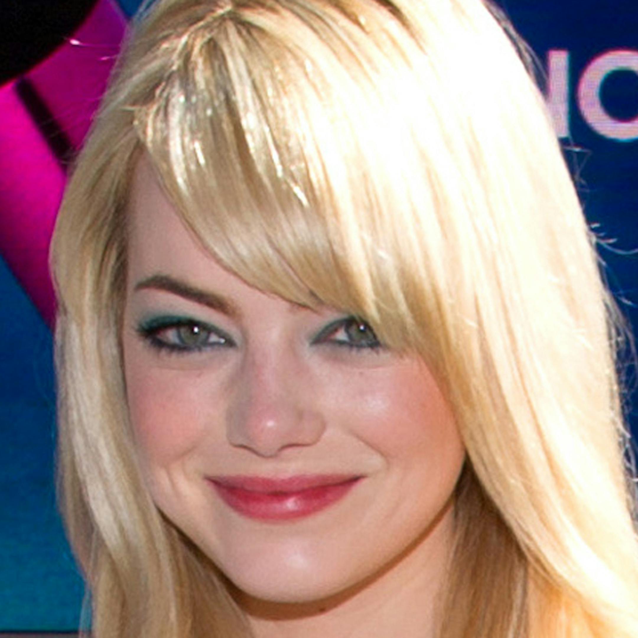 Actress Emma Stone poses in Times Square as she launches the new Revlon Lash Potion Mascara on the Walgreens jumbotron, Wednesday April 24, 2013 in New York. Stone is a global brand ambassador for Revlon. (Photo by Evan Agostini/Invision/AP) ORG XMIT: MIN2013042512263590