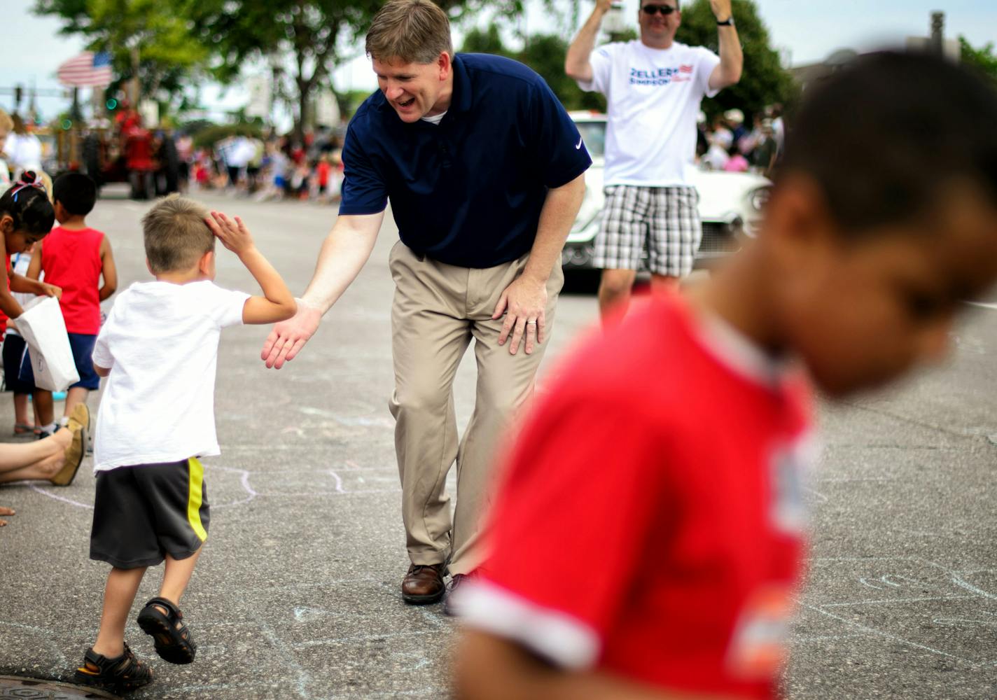 Kurt Zellers, one of four serious contenders for the GOP primary for governor, got high-fives from kids along the parade route at the Chanhassen Fourth of July parade, July 4, 2014 ] GLEN STUBBE * gstubbe@startribune.com