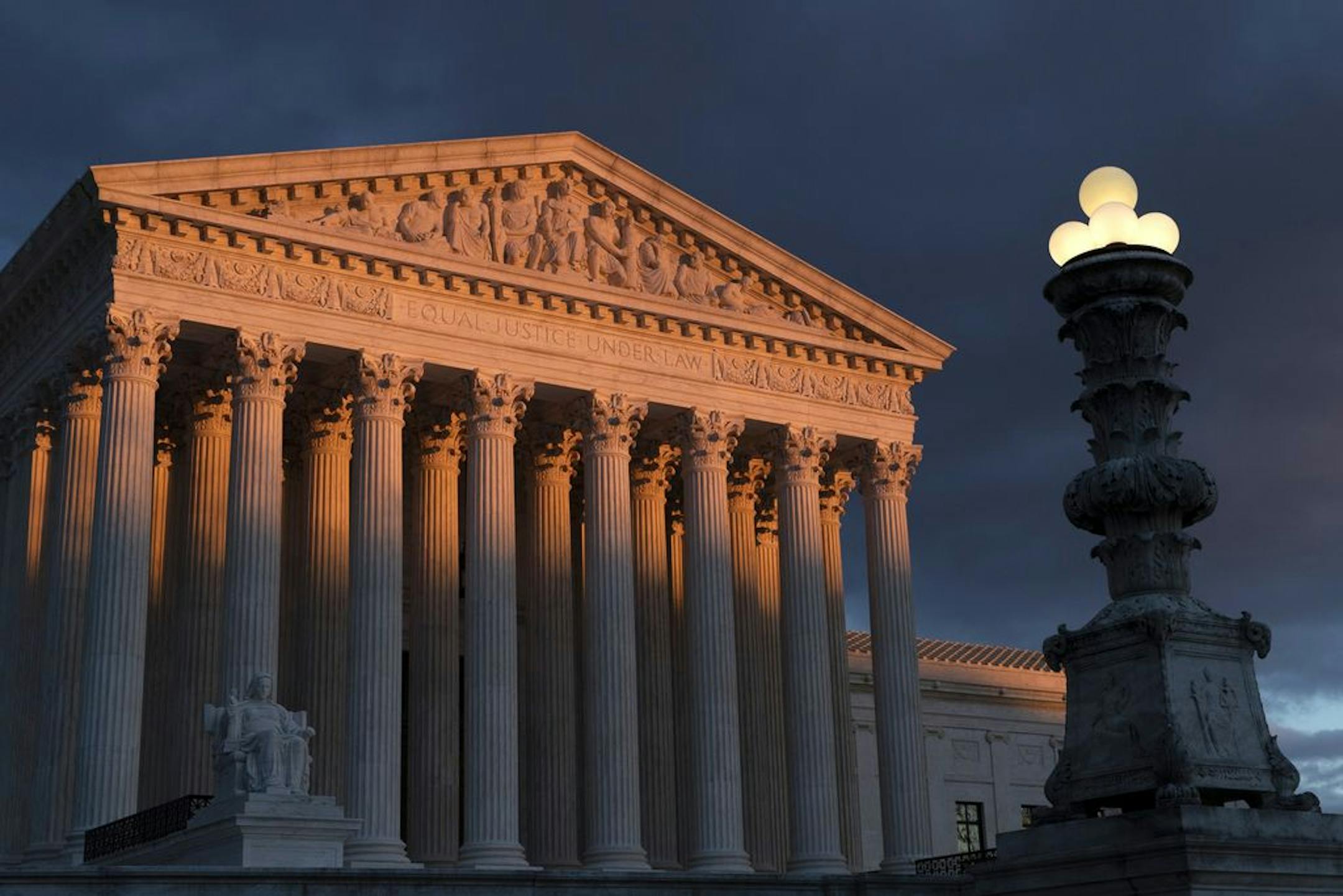 FILE - In this Jan. 24, 2019 file photo, the Supreme Court is seen at sunset in Washington. The Supreme Court has ruled that insurance companies can collect $12 billion from the federal government to cover their losses in the early years of the health care law championed by President Barack Obama. The justices voted 8-1 Monday in holding that insurers are entitled to the money under a provision of the "Obamacare" health law that promised the companies a financial cushion for losses they might in