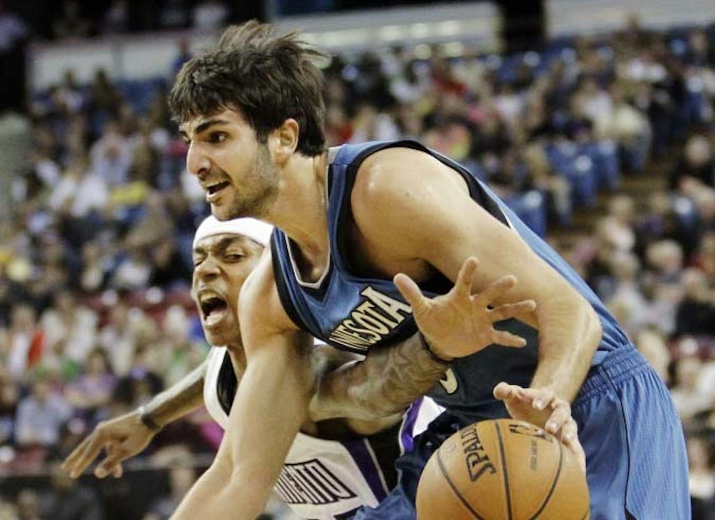 Sacramento Kings guard Isaiah Thomas, left, reaches in for the ball against Timberwolves guard Ricky Rubio during the first quarter Thursday in Sacramento, Calif.