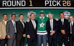 Goalie Jake Oettinger, center, a Lakeville native, wore a Dallas Stars jersey after being selected by the team during the first round of the NHL draft