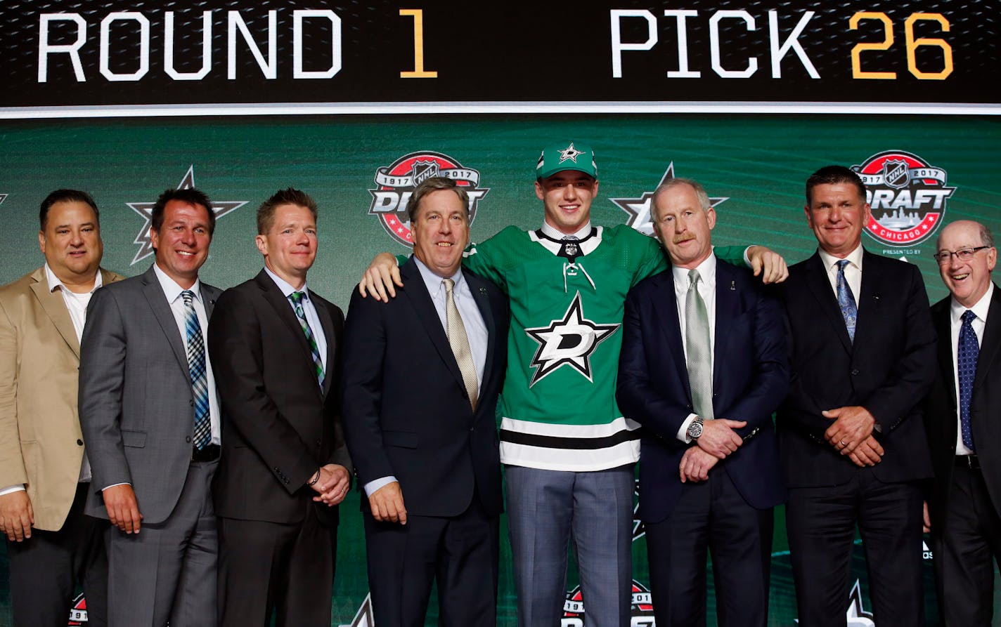 Goalie Jake Oettinger, center, a Lakeville native, wore a Dallas Stars jersey after being selected by the team during the first round of the NHL draft on Friday.