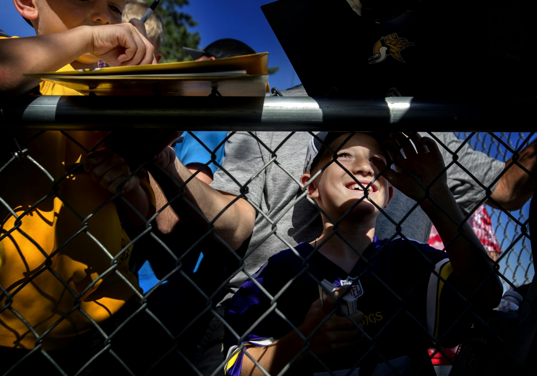 Minnesota Vikings fans Chase Urban, 7, and brother Carson, 10, from Amboy, MN got autographs from players after the end of the afternoon practice.