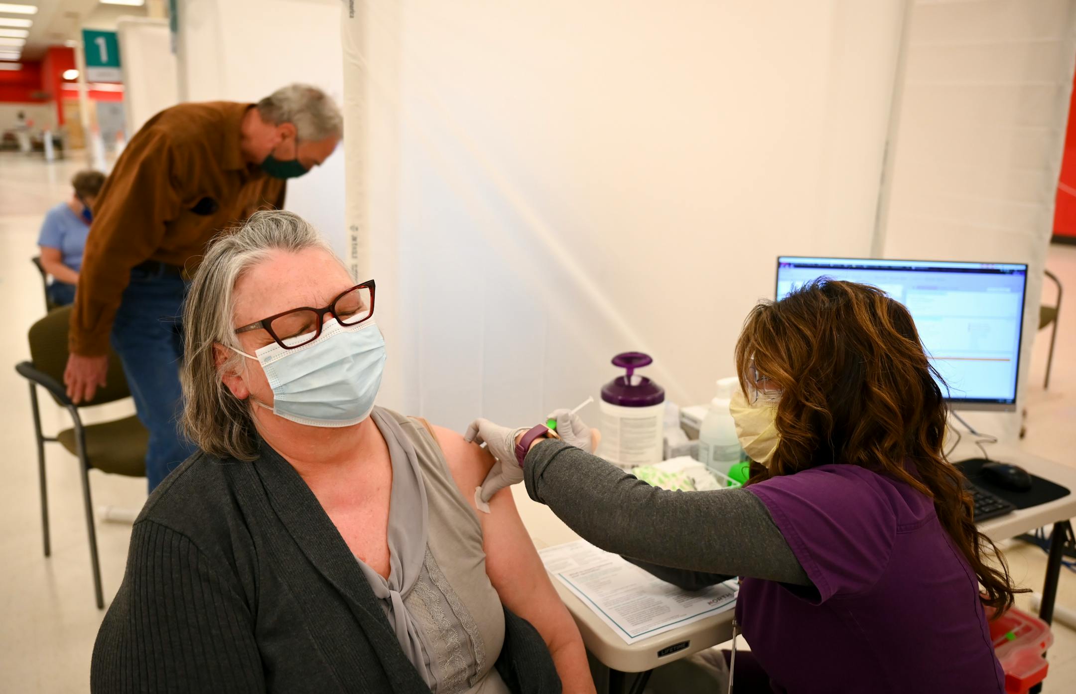 Nancy Andrews, of Fridley, received a dose of the Moderna COVID-19 vaccine, administered by nurse Jilll Blekestad, Tuesday afternoon at North Memorial Health Hospital's vaccination clinic in Brooklyn Center.