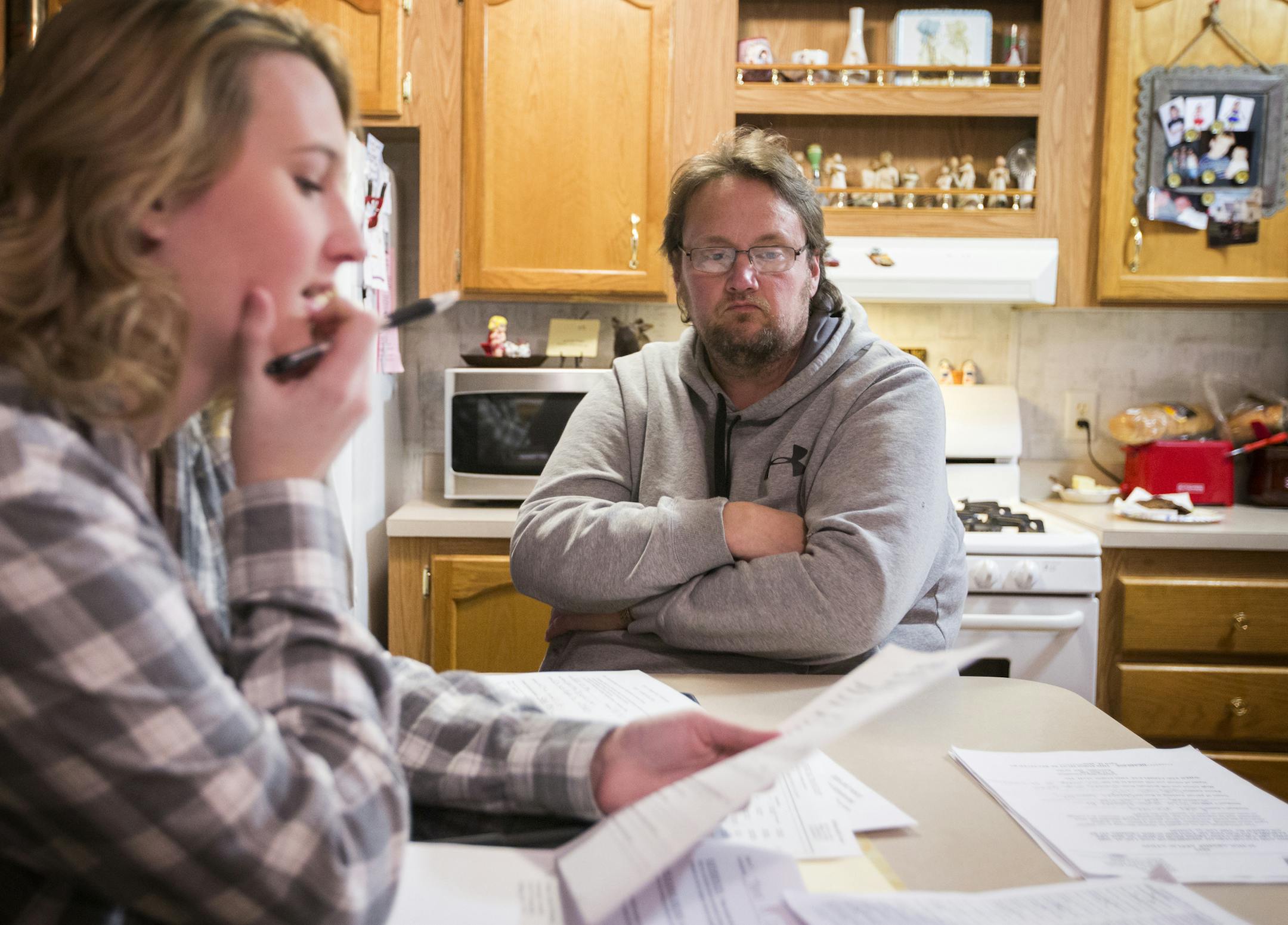 Laid-off millwright Douglas Whitney helped daughter Rylee, 18, fill out scholarship forms. She plans to attend St. Scholastica in the fall.