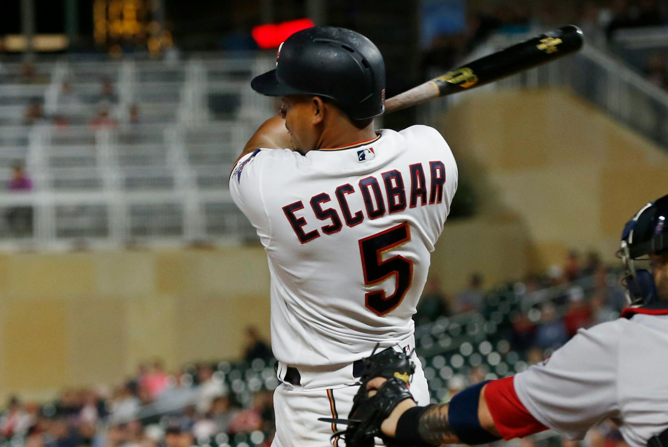 Minnesota Twins' Eduardo Escobar follows through on an RBI single off Boston Red Sox pitcher Joe Kelly during the eighth inning of a baseball game Tuesday, June 19, 2018, in Minneapolis. Escobar had three RBIs as the Twins won 6-2. (AP Photo/Jim Mone)