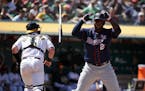 The Twins' Miguel Sano tossed his bat after striking out as Athletics catcher Chris Herrmann ran to the dugout during the seventh inning of Oakland's 