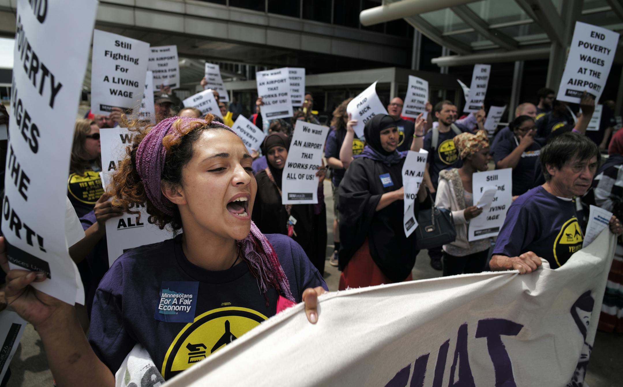 At the MSP airport on June 16, 2014, SEIU members and supporters demanded higher wages for the service workers that work there including Elsabet Binyam, far left .]richard.tsong-taatarii/rtsong-taatarii@startribune.com