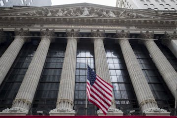 FILE- In this Nov. 20, 2018, file photo an American flag flies outside New York Stock Exchange. The stock market hasn't been this dizzying in years, a