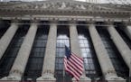 FILE- In this Nov. 20, 2018, file photo an American flag flies outside New York Stock Exchange. The stock market hasn't been this dizzying in years, a