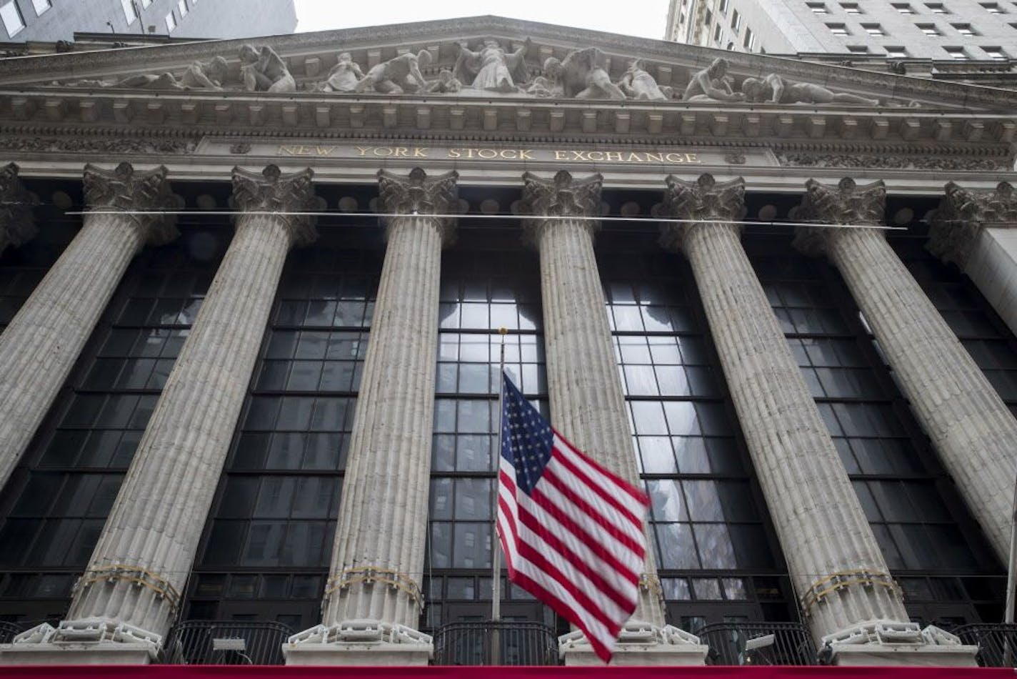 FILE- In this Nov. 20, 2018, file photo an American flag flies outside New York Stock Exchange. The stock market hasn't been this dizzying in years, and investors may need to get used to it. The S&P 500 slid 4.6 percent this past week as worries piled up about the economy's strength, global trade and interest rates. It was an abrupt turnaround from the prior week, when the S&P 500 jumped 4.8 percent. The last time investors experienced such a big swing in stock prices between two weeks was in la