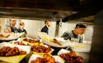 The kitchen crew kept meals flowing to customers during a busy lunchtime at the start of the NCAA tournament. Buffalo Wild Wings at the University of 