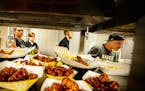 The kitchen crew kept meals flowing to customers during a busy lunchtime at the start of the NCAA tournament. Buffalo Wild Wings at the University of 