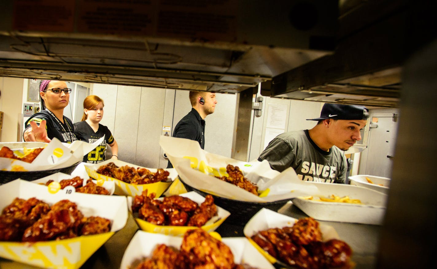 The kitchen crew kept meals flowing to customers during a busy lunchtime at the start of the NCAA tournament. Buffalo Wild Wings at the University of Minnesota ] GLEN STUBBE * gstubbe@startribune.com Thursday, March 20, 2014.