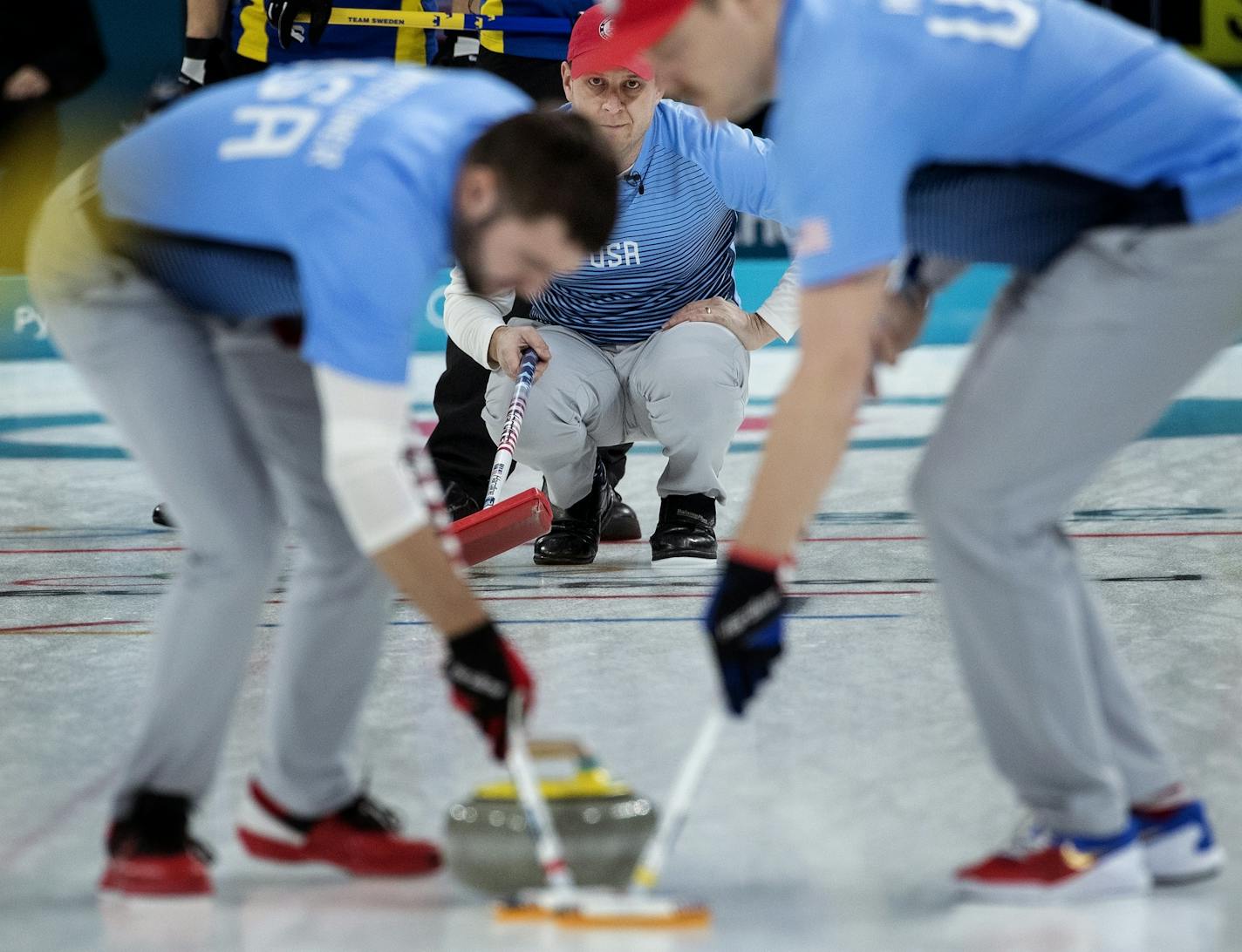 Team skip John Shuster watched John Landsteiner and Matt Hamilton sweep in front of the rock.