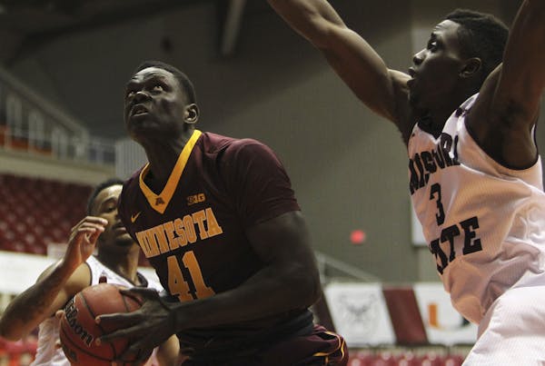 Missouri State guard Loomis Gerring, right, looks to shoot pressured by Minnesota forward Gaston Diedhiou, during the Puerto Rico Tip-Off college bask