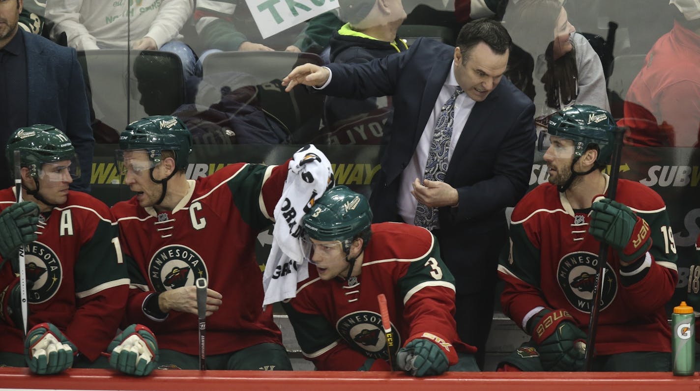 Wild head coach John Torchetti talked with Wild center Jarret Stoll (19) on teh bench in the third period.