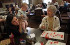 Elsie Gustavson, 94, played bingo at her assisted living facility in Maplewood, while baby Elsie Williams and her mother, Amy, kept her company.