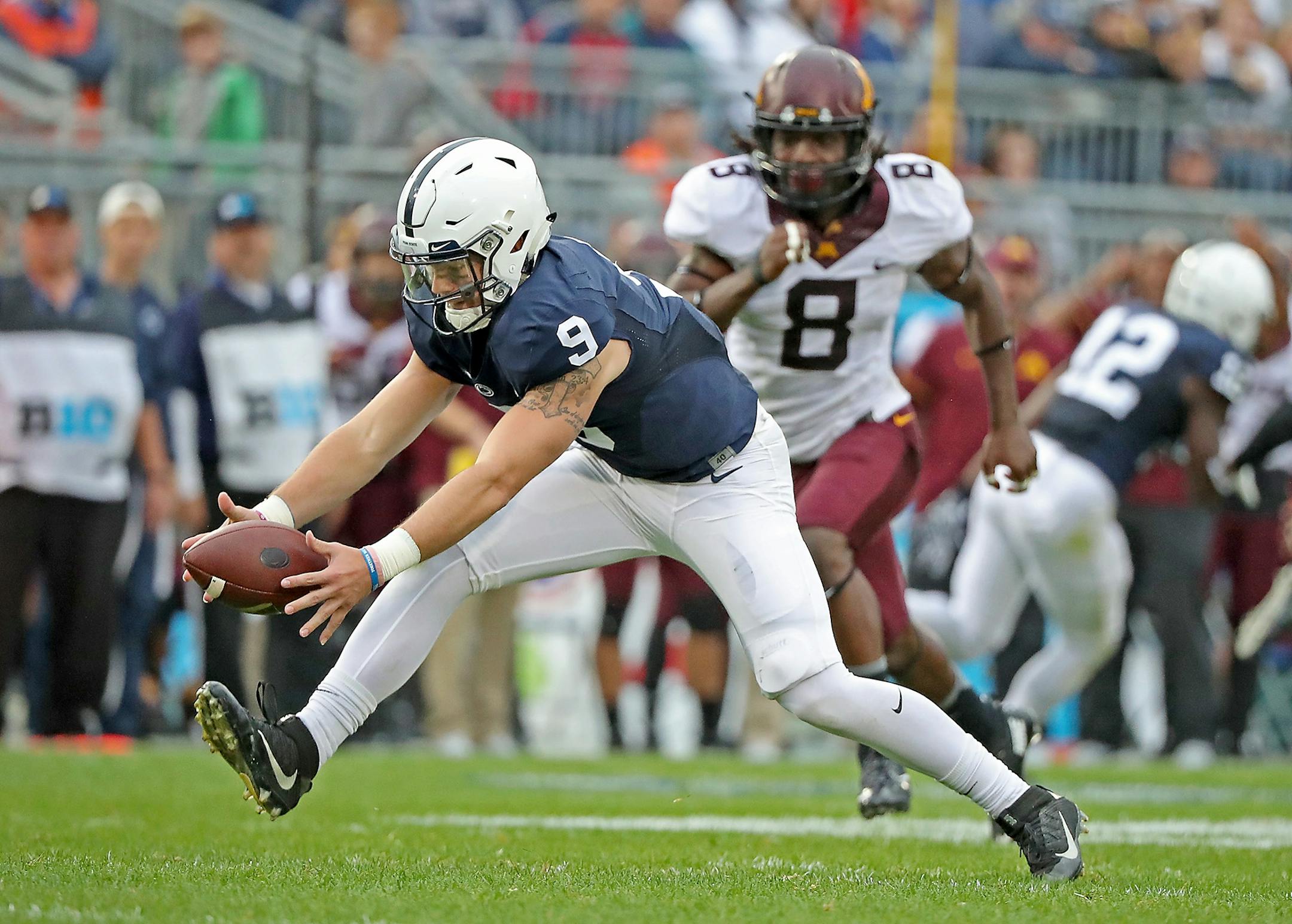 Penn State's quarterback Trace McSorley lost the ball and recovered it after the snap as he was taken on by Minnesota's defensive back Duke McGhee in the second quarter as Minnesota took on Penn State at Beaver Stadium, Saturday, October 1, 2016 in State College, PA.